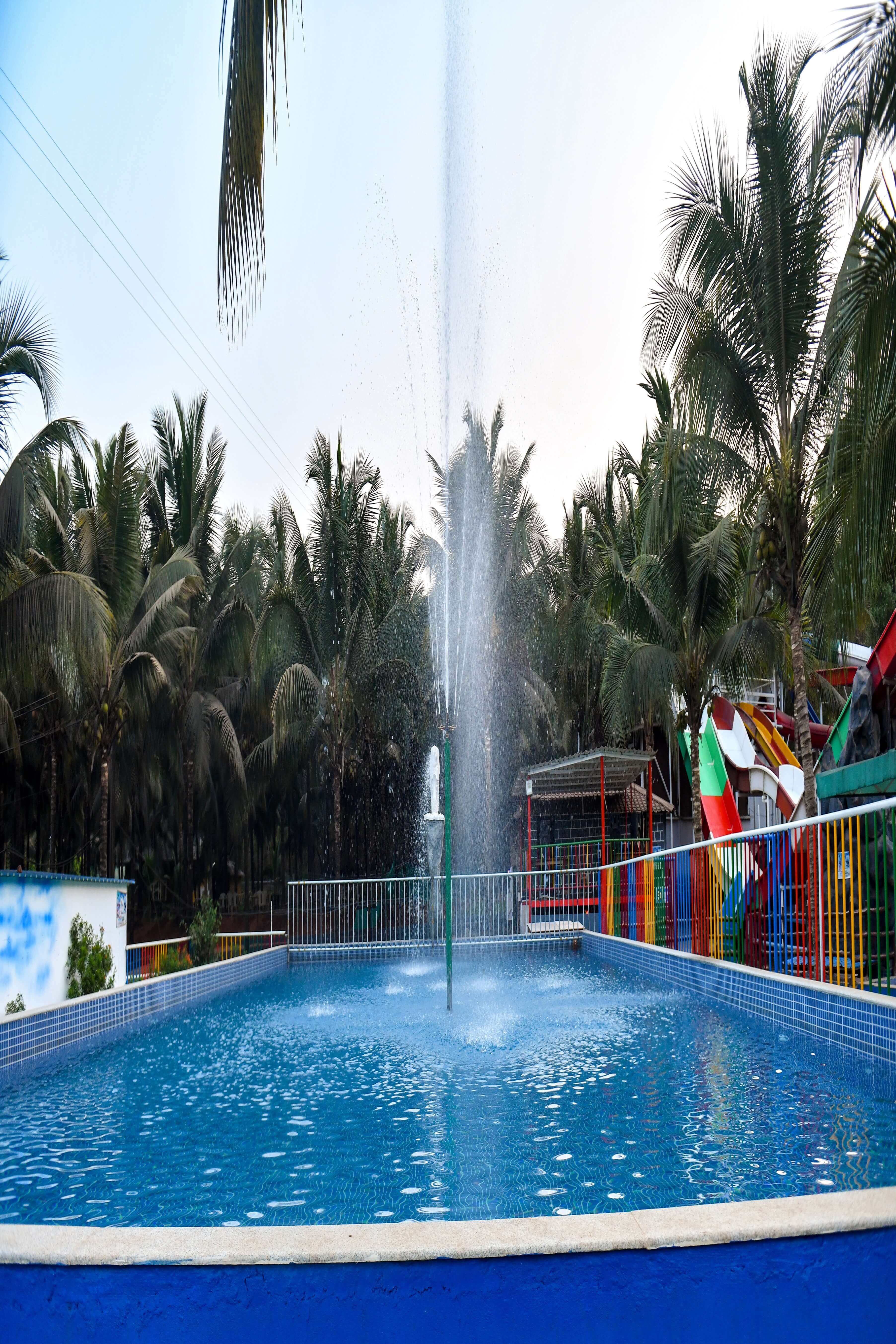 Visitor walking confidently on a rope bridge adventure activity, showcasing fun and excitement at Goa Aqua World.